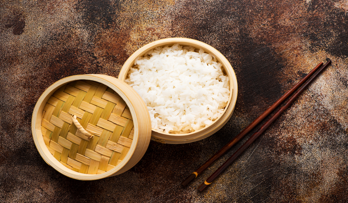 jasmine rice cooked in a bamboo steamer with chopsticks