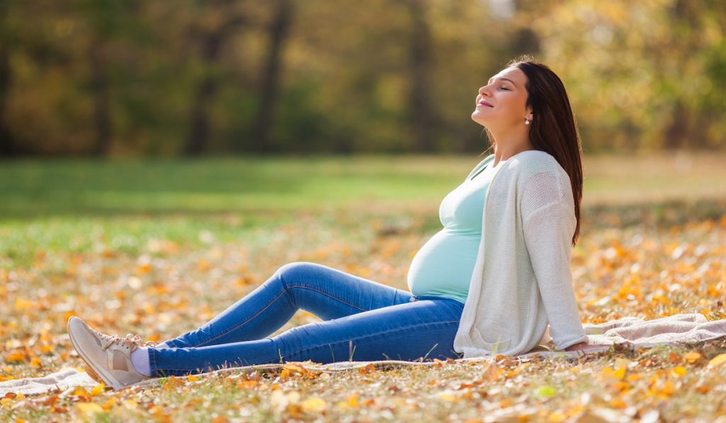 pregnant woman relaxing at the park