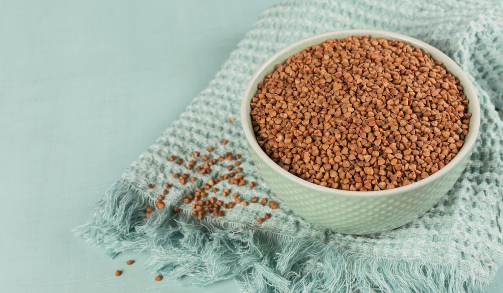 Buckwheat groats close up. Grains of raw buckwheat as a background texture