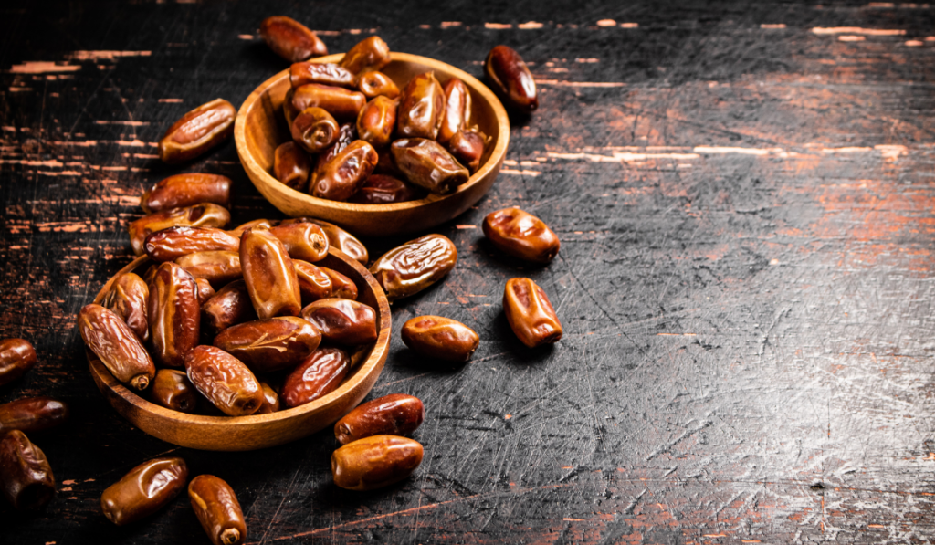 Delicious dates on a wooden plate.