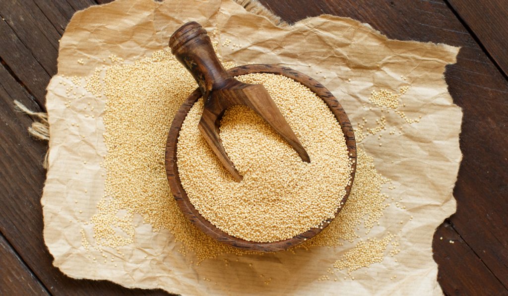 Raw Organic Amaranth grain on wooden bowl