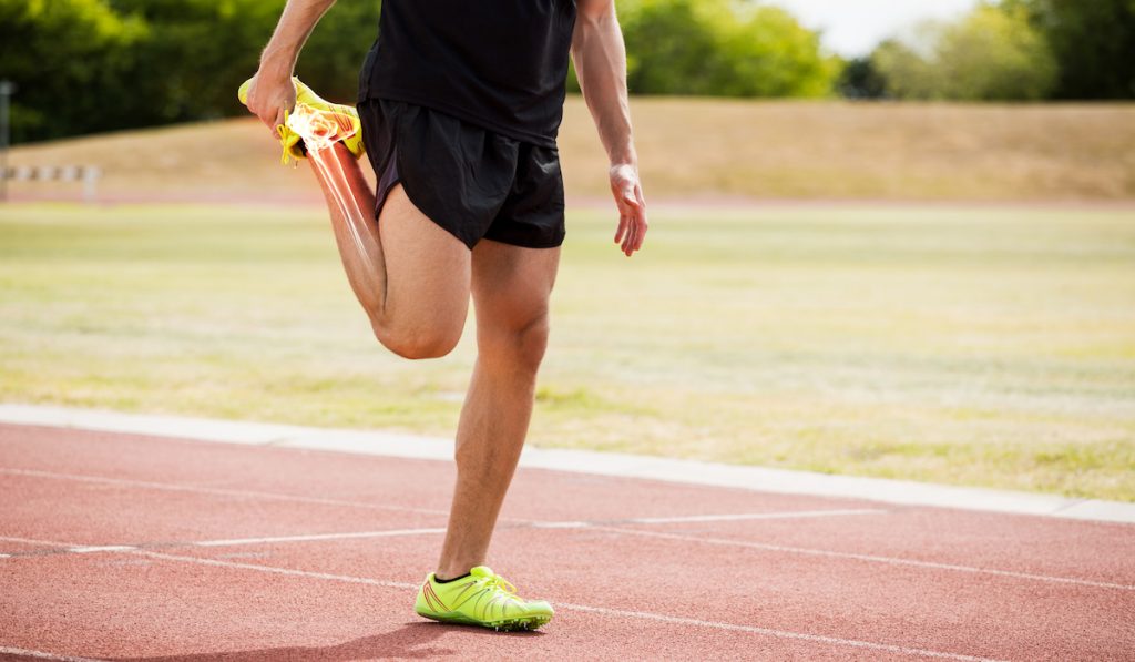 highlighted bones of a runner while stretching 