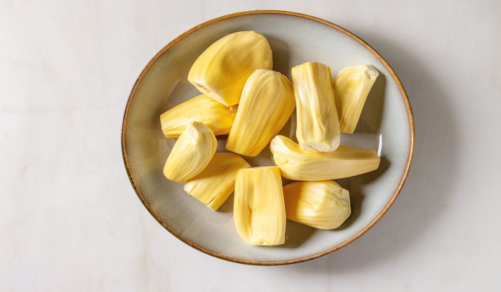 ripe and peeled jackfruit on a white bowl 