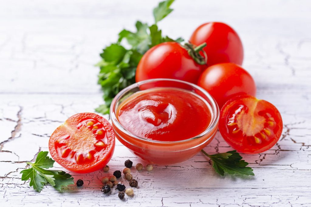 tomato ketchup sauce on white wooden table 