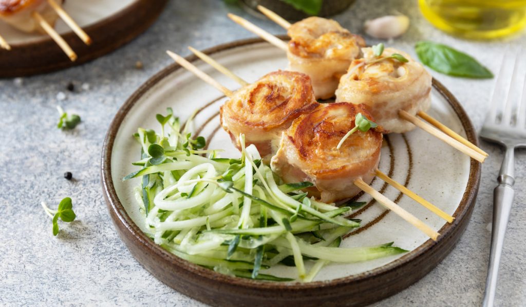 Rolls bacon wrapped chicken with cucumber noodles